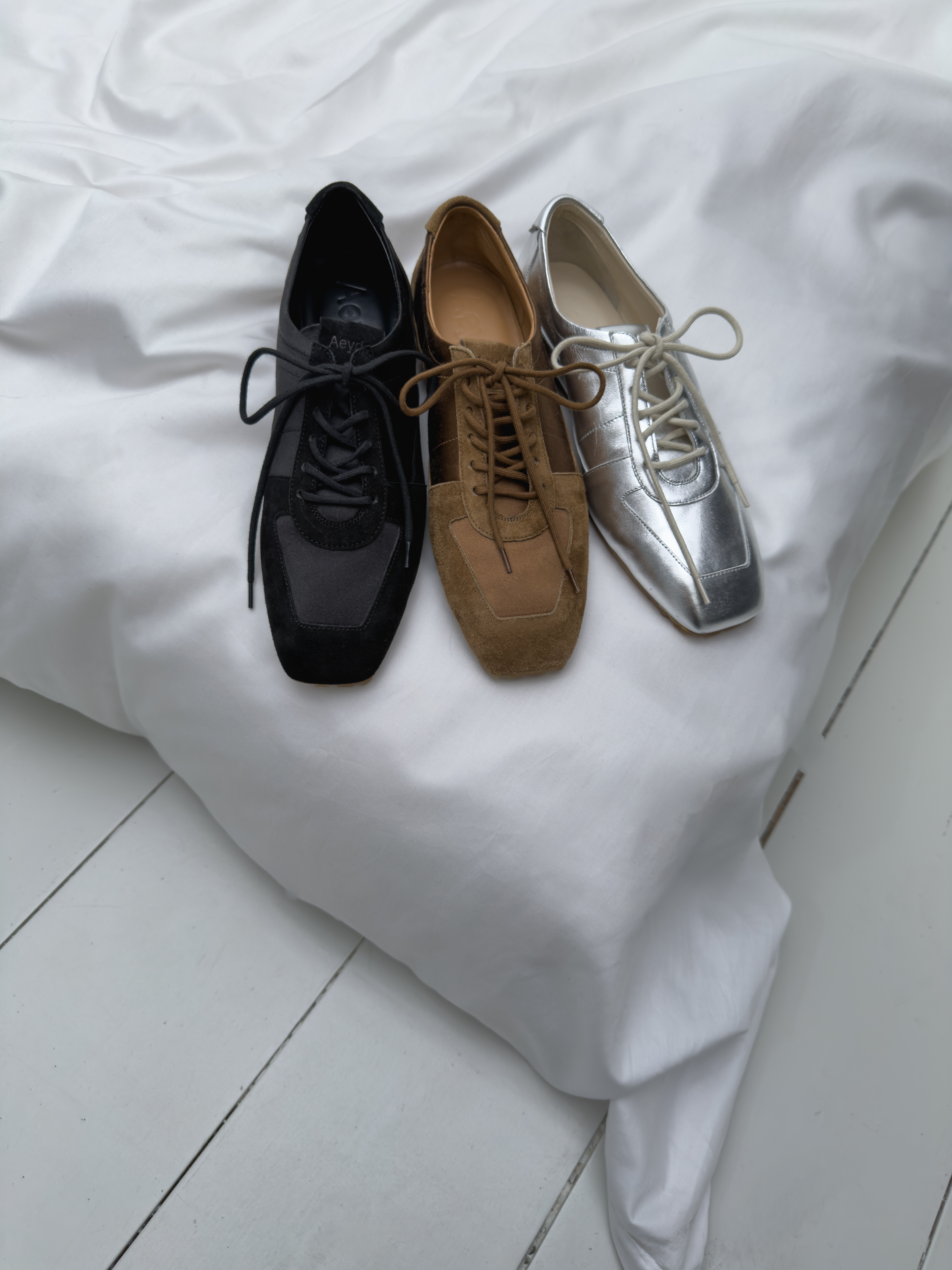 Retro runnersAeyde introduces its first sneaker: a clean, subtly sporty silhouette inspired by its popular square toe Mary-Jane style. Available in seasonal shades including pale blue, tobacco, peach and silver in a mix of satin and soft suede. Style with jeans for a twist on a classic preppy look.£390, Aeyde