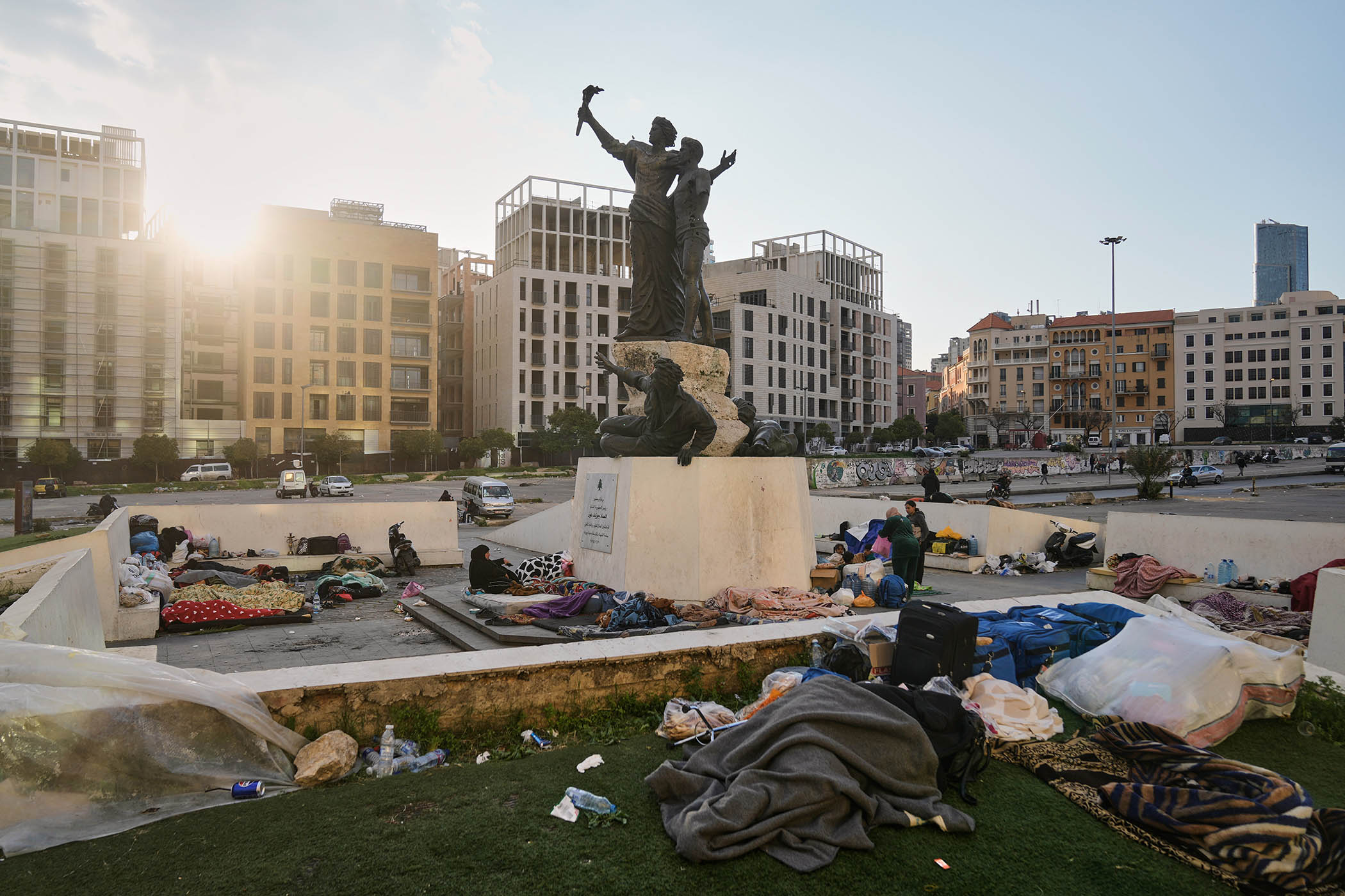 Displaced people fleeing Israeli airstrikes in Dahiyeh, Beirut's southern suburbs, sleep at Martyrs' Square in downtown Beirut.
